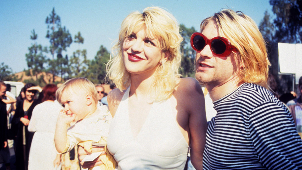 Kurt Cobain of Nirvana (right) with wife Courtney Love and daughter Frances Bean Cobain (Photo by Terry McGinnis/WireImage)
