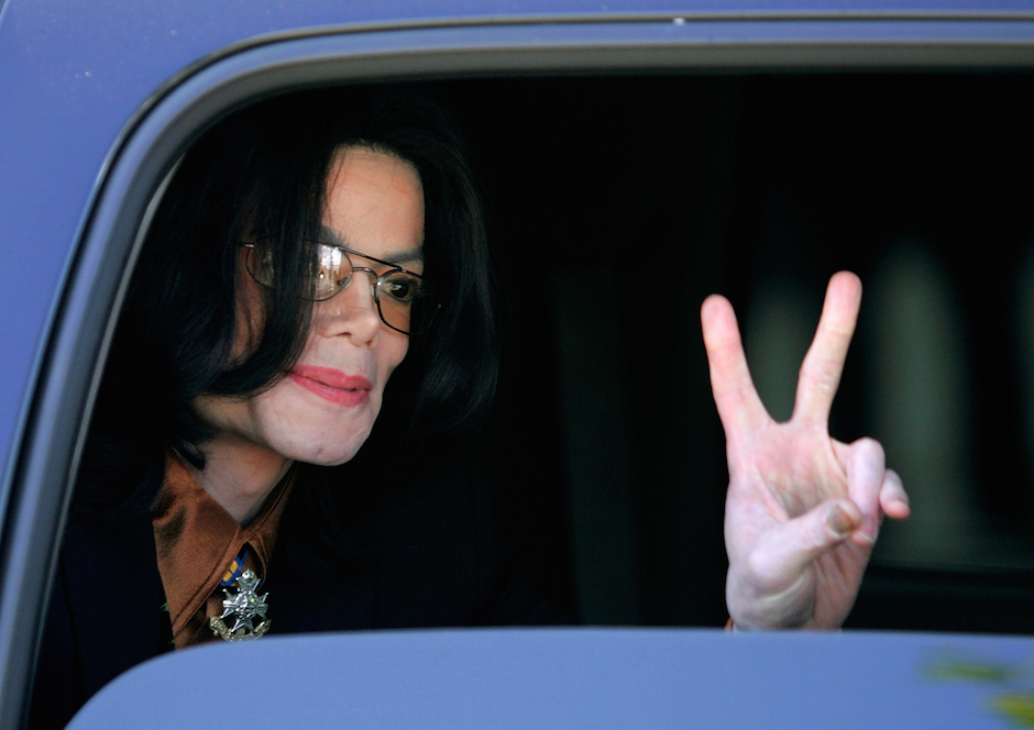 SANTA MARIA, CA - FEBRUARY 24:  Singer Michael Jackson flashes a "V" sign to fans from inside a vehicle as he departs the ...