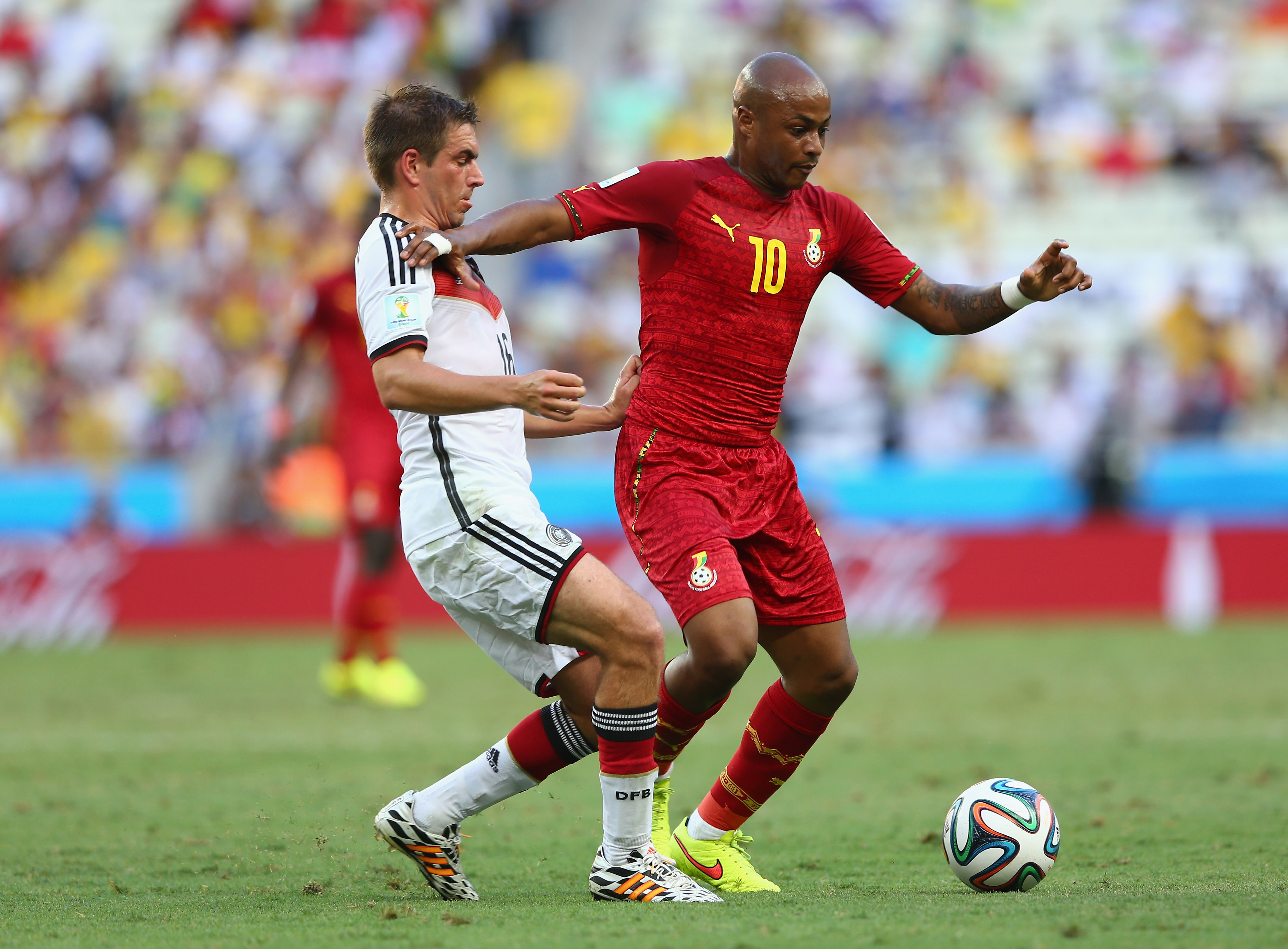FORTALEZA, BRAZIL - JUNE 21:  Philipp Lahm of Germany challenges Andre Ayew of Ghana during the 2014 FIFA World Cup Brazil...