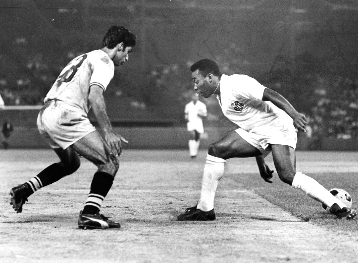 JULY 8: The Boston Beacons' Jorge Miguel (#13), left, defends against Santos FC's Pele during a soccer game at Fenway Park...