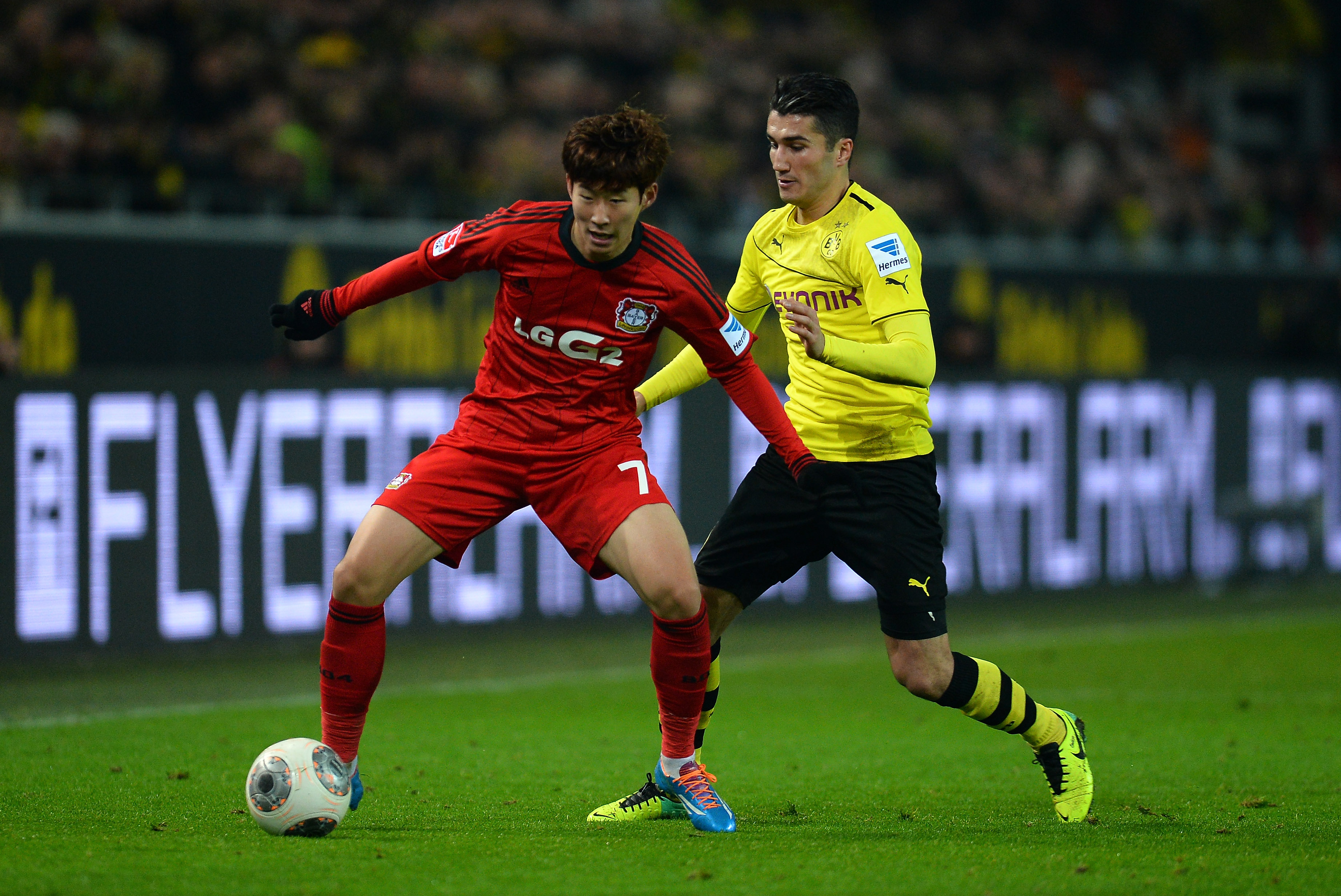 DORTMUND, GERMANY - DECEMBER 07:  Heung Min Son of Leverkusen is challenged by Nuri Sahin of Dortmund during the Bundeslig...