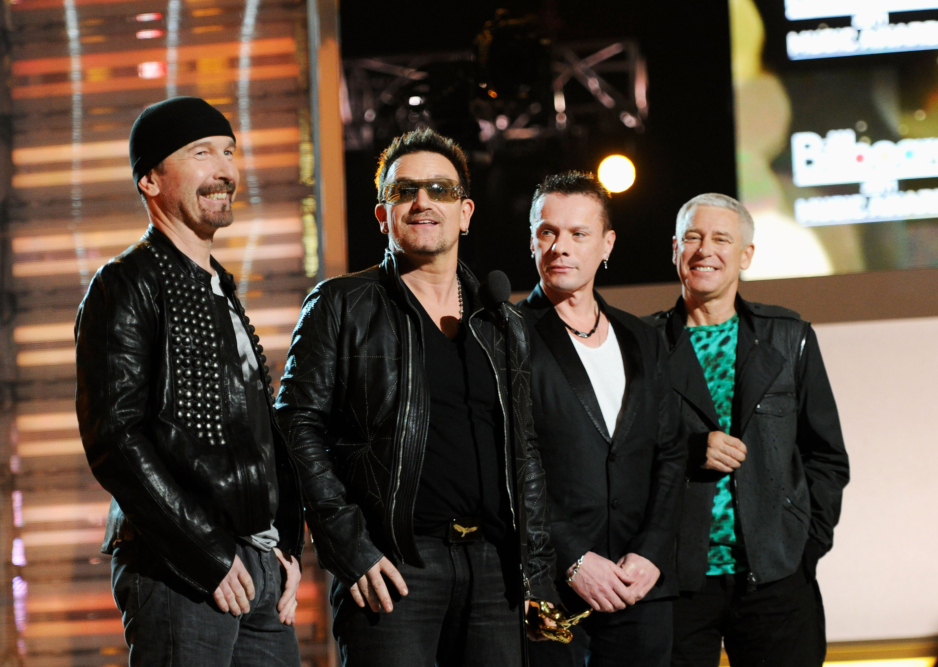 Musicians The Edge, Bono, Larry Mullen Jr. and Adam Clayton of the band U2 speak onstage during the 2011 Billboard Music A...