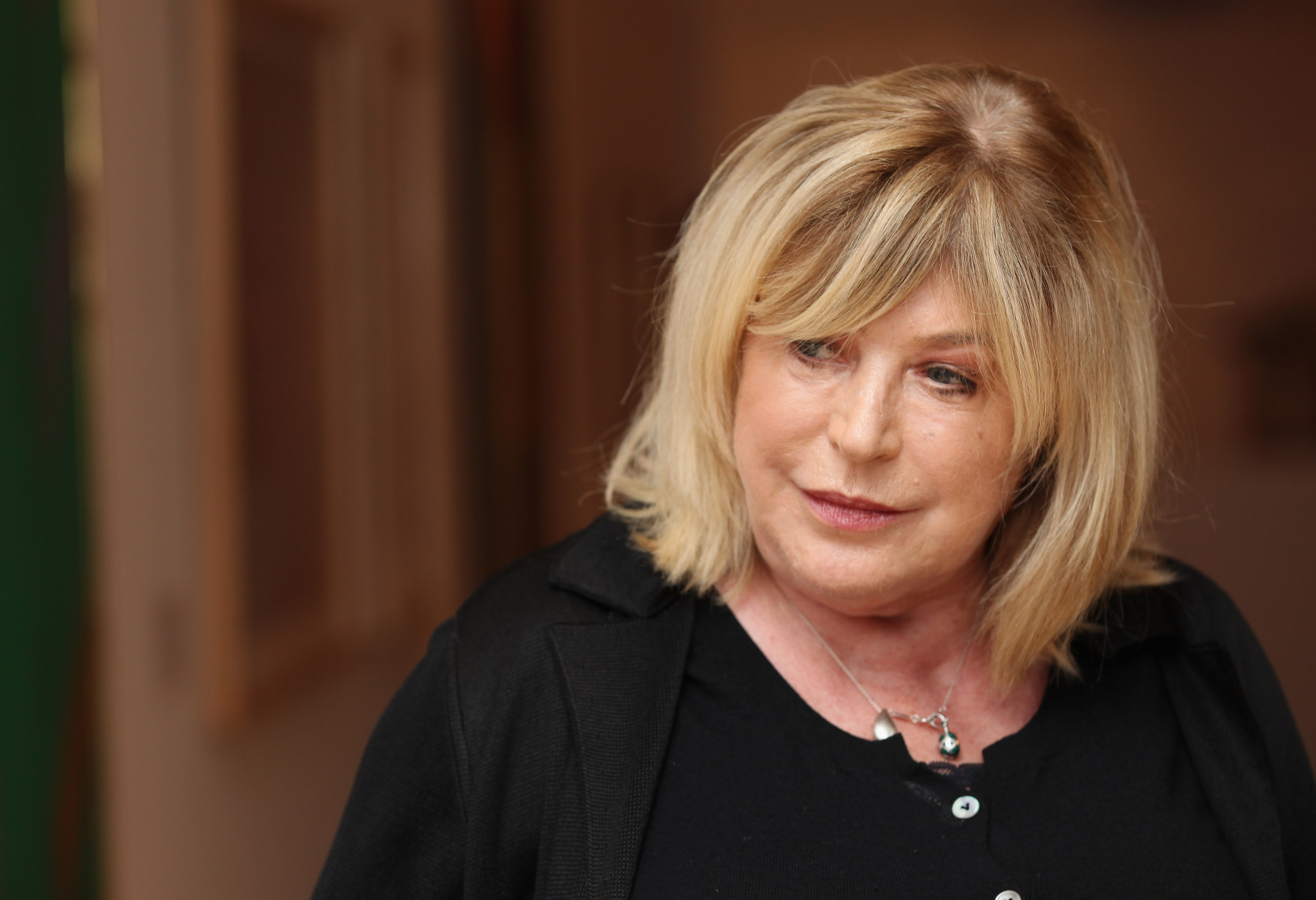LIVERPOOL, ENGLAND - APRIL 20:  Singer-songwriter Marianne Faithfull poses next to artworks as she opens the Innocence And...