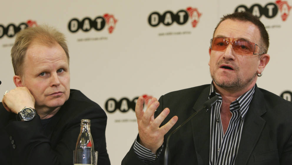 BERLIN - MAY 15:  Musicians Bono (R) and Herbert Groenemeyer speak during a news conference after the presentation of DATA (D