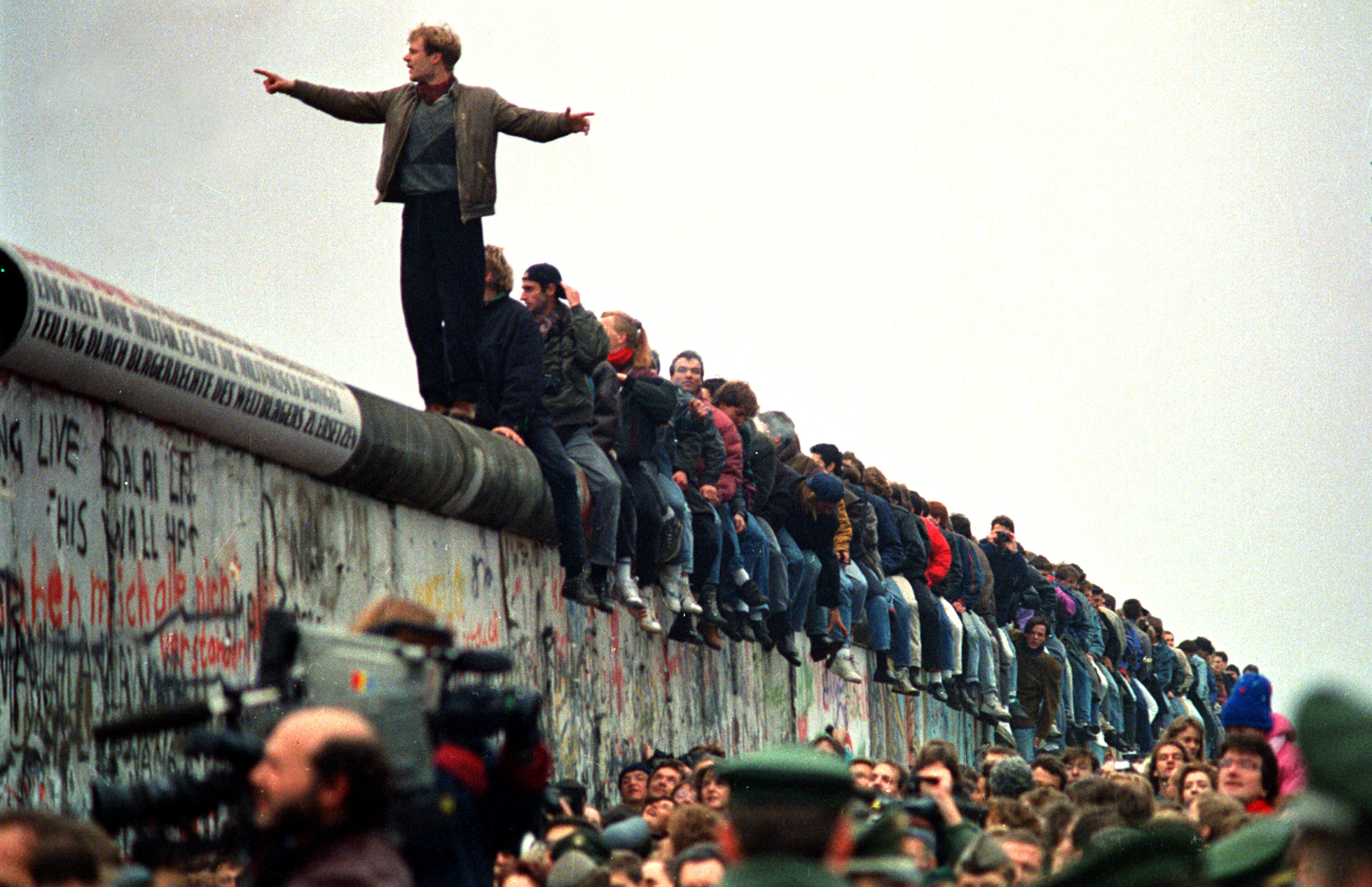 WEST BERLIN - NOVEMBER 11: People stand on a section of the Berlin Wall at Potsdamer Platz. (Photo by John Tlumacki/The Bo...