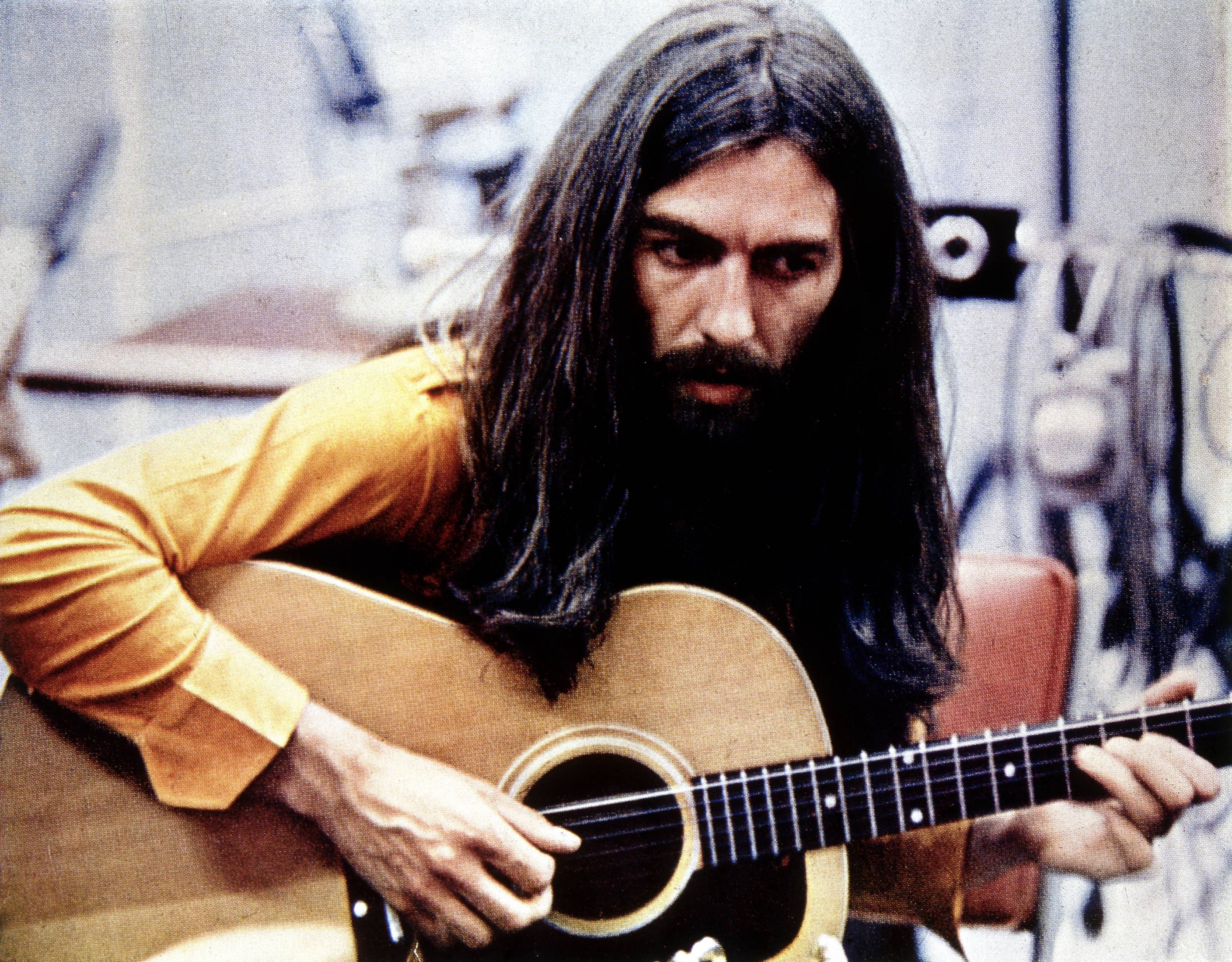 UNSPECIFIED - JANUARY 01:  (AUSTRALIA OUT) Photo of George HARRISON; playing acoustic guitar, c.1970/1971  (Photo by GAB A...