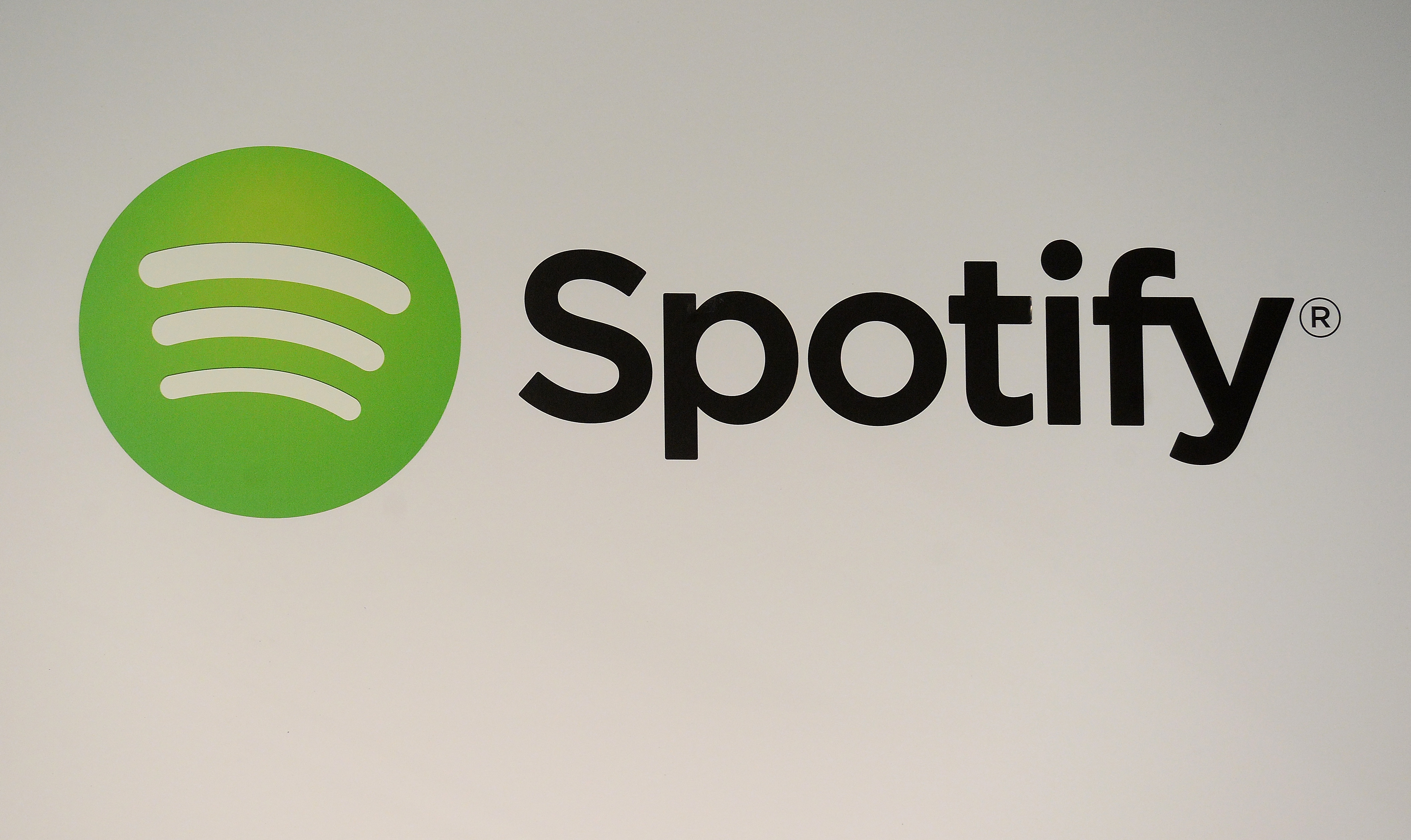 A Spotify logo is seen as founder and CEO Daniel Ek addresses a press conference in New York, December 11, 2013. The music...