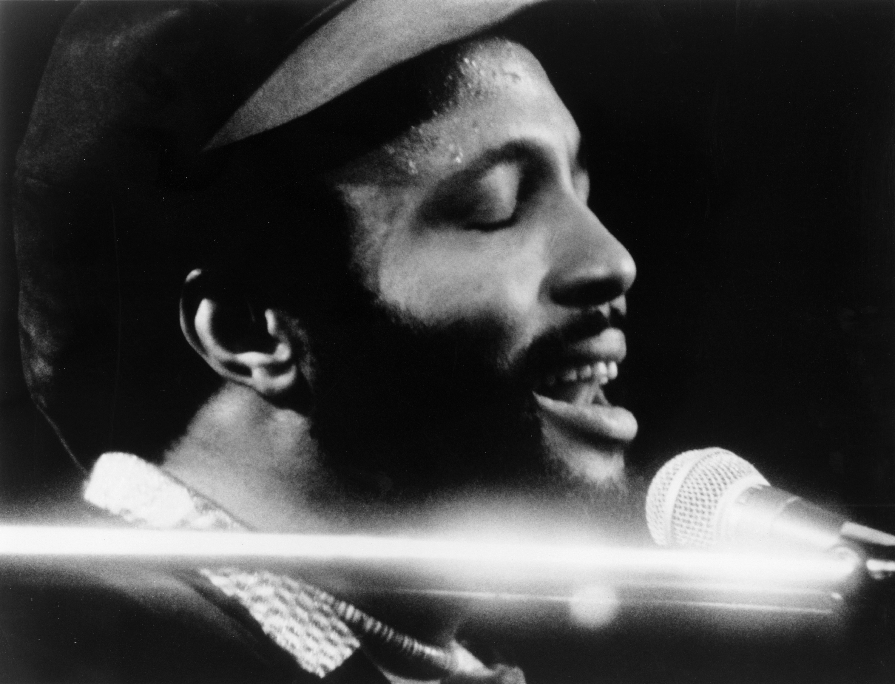 CIRCA 1976: Singer and composer Andrae Crouch plays the piano as he sings in to a microphone in circa 1976. (Photo by Mich...