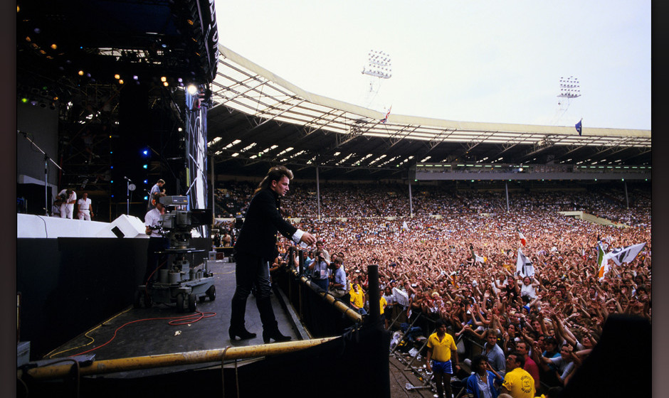 LONDON - JULY 13: Bono performs on stage during the Live Aid concert at Wembley Stadium on 13 July, 1985 in London, England. 