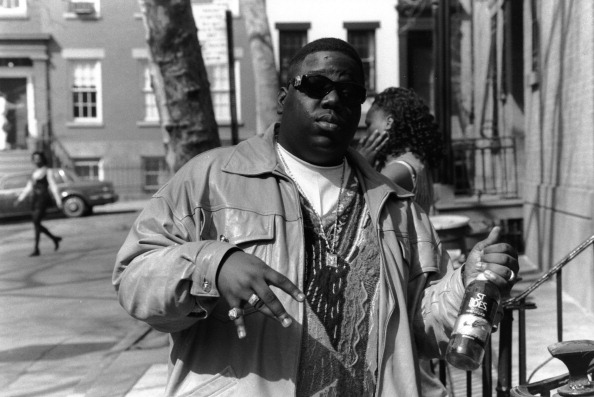 American rapper Biggie Smalls (also known as the Notorious B.I.G., born Christopher Wallace, 1972 - 1997) holds a bottle o...