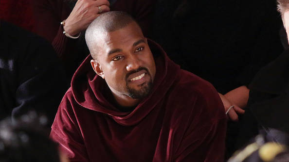 NEW YORK, NY - FEBRUARY 18:  Kanye West watches the Jeremy Scott fall 2015 fashion show at Milk Studios on February 18, 2015 