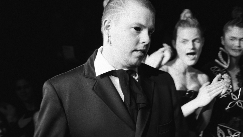 NEW YORK - MARCH 1996:  British fashion designer Alexander McQueen with unidentified models in the background at a show of hi