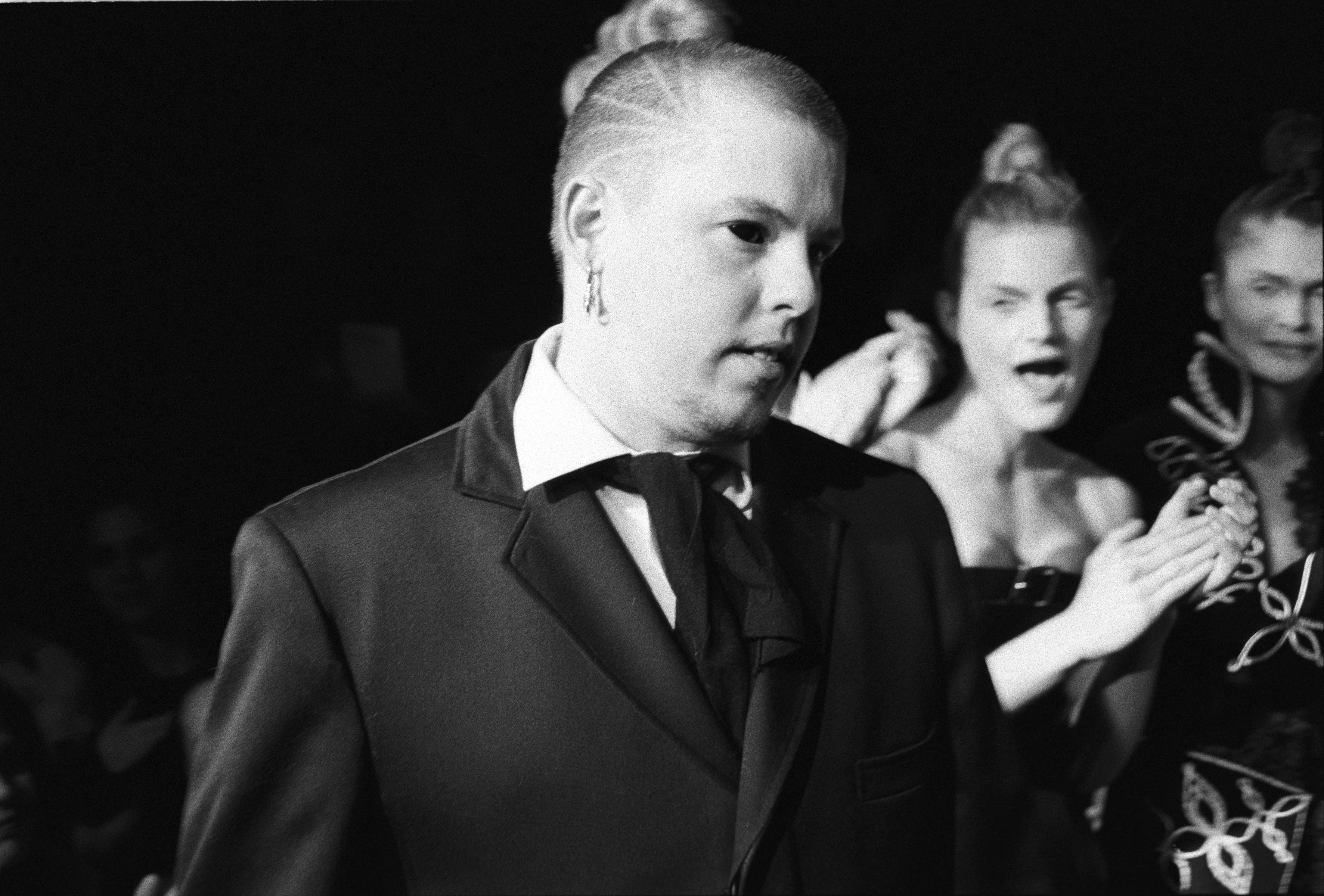 NEW YORK - MARCH 1996:  British fashion designer Alexander McQueen with unidentified models in the background at a show of...