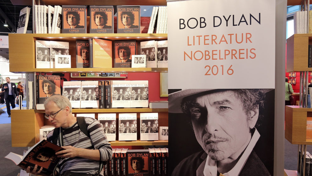 FRANKFURT AM MAIN, GERMANY - OCTOBER 19:  A man reads a book about Bob Dylan at the 2016 Frankfurt Book Fair (Frankfurter Buc
