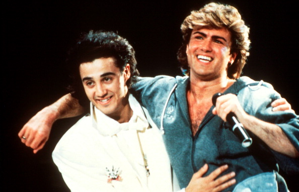 Andrew Ridgeley and George Michael of Wham performing on stage in 1985. (Photo by Michael Putland/Getty Images)