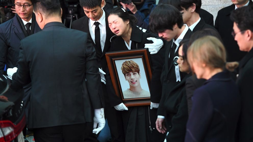 TOPSHOT - Family members and friends of late SHINee singer Kim Jong-Hyun cry as they carry out his coffin during a funeral at