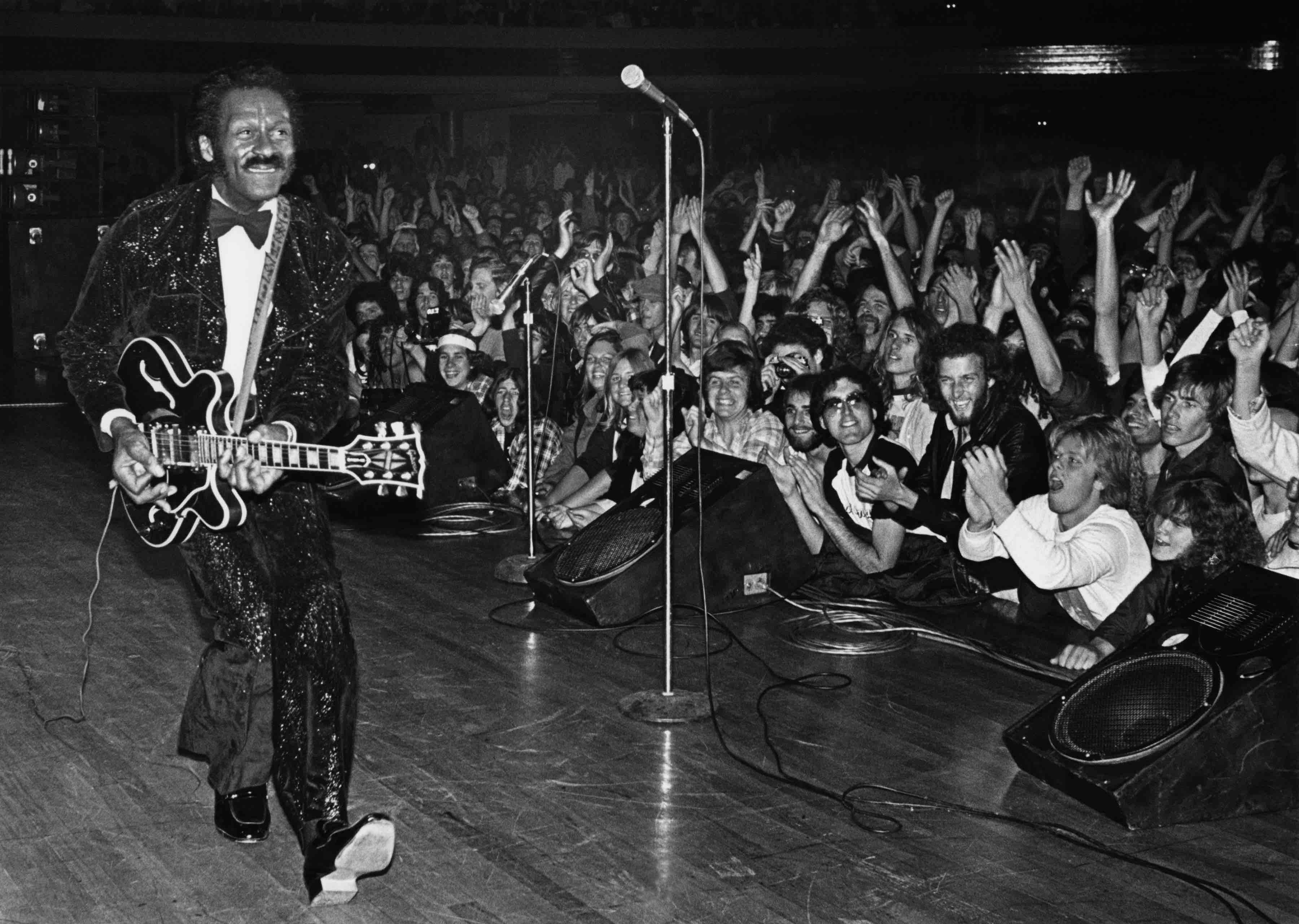 HOLLYWOOD, CA - 1980:  Rock and roll legend Chuck Berry struts his signature "duck walk" while playing his Gibson guitar, ...