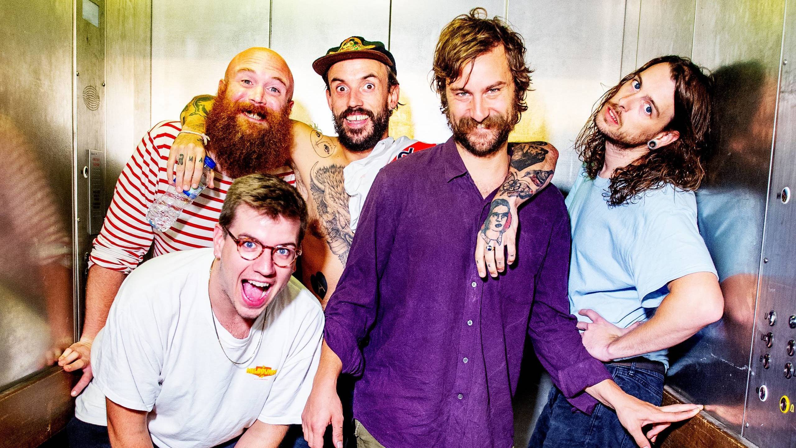 Adam Devonshire, Jon Beavis, Joe Talbot, Mark Bowen and Lee Kiernan of Idles pose backstage after performing live and sign...