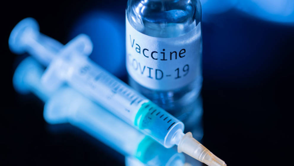 TOPSHOT - This picture taken on November 17, 2020 shows a syringe and a bottle reading 'Vaccine Covid-19'. - According to the