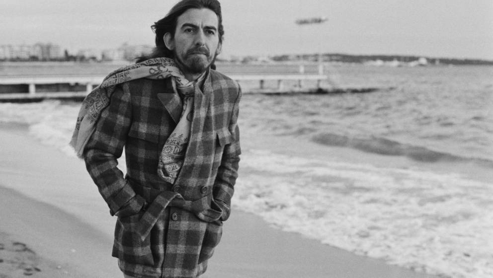 English singer-songwriter, guitarist and former Beatle, George Harrison (1943 - 2001) on the beach in Cannes, France, 30th Ja
