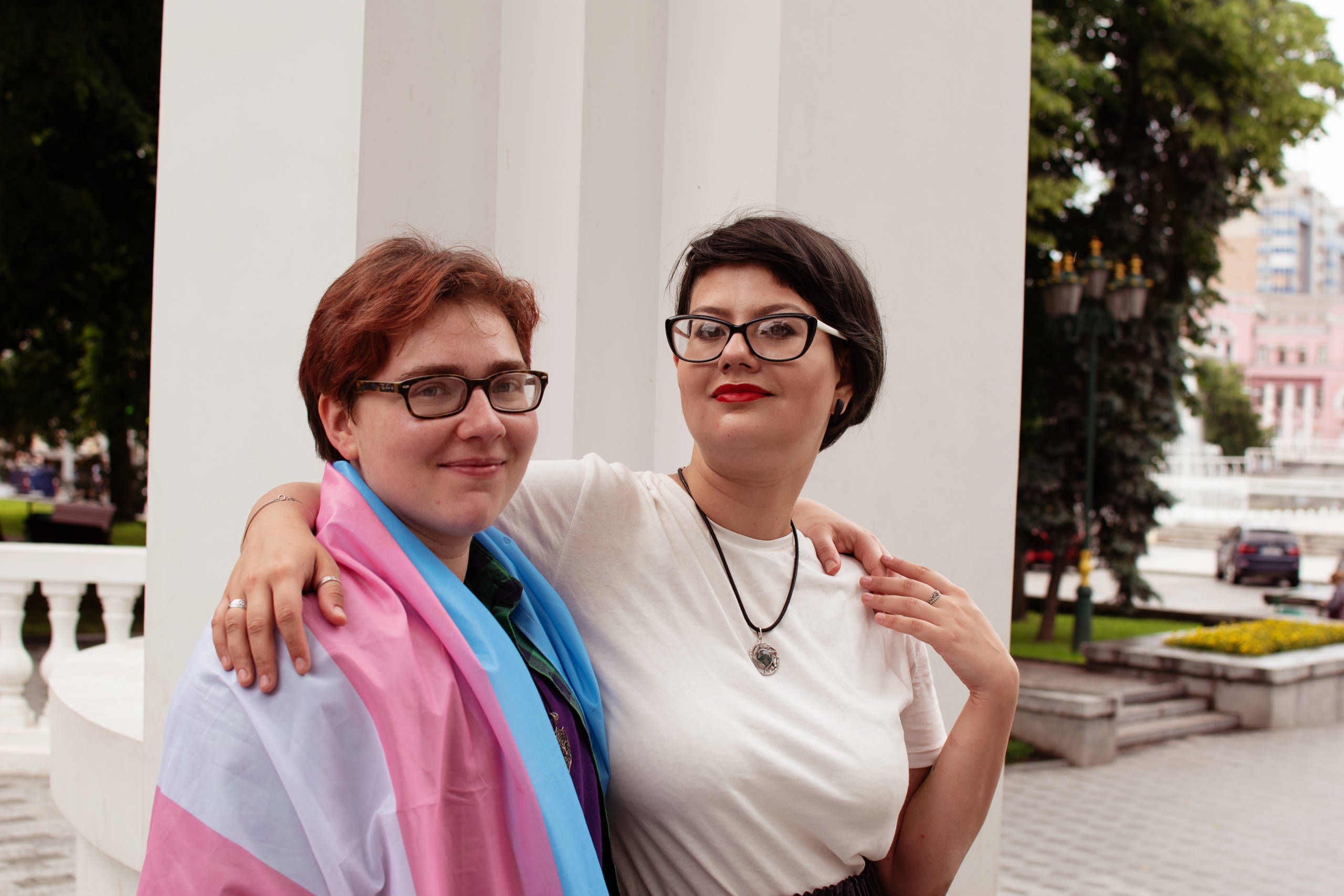 Ein trans Mann mit seiner Freundin mit einer Trans-Flagge in der ukrainischen Stadt Kharkiv.