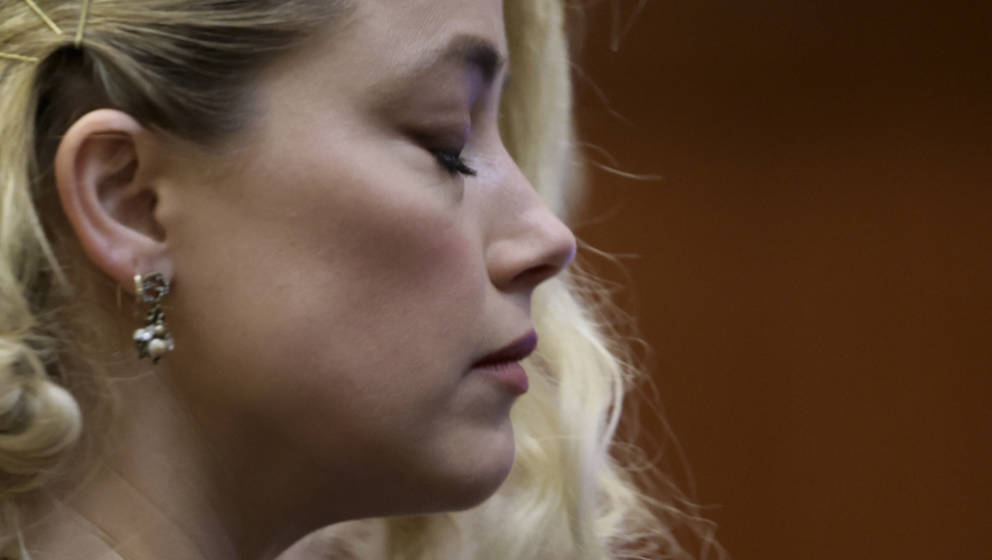 TOPSHOT - US actress Amber Heard waits before the jury announced a split verdict in favor of both Johnny Depp and Amber Heard