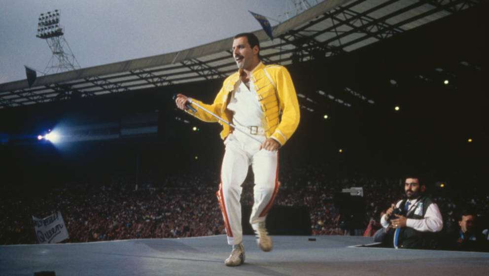 Singer Freddie Mercury (1946 - 1991) performing with Queen at Wembley Stadium, London, July 1986. The band played two nights 