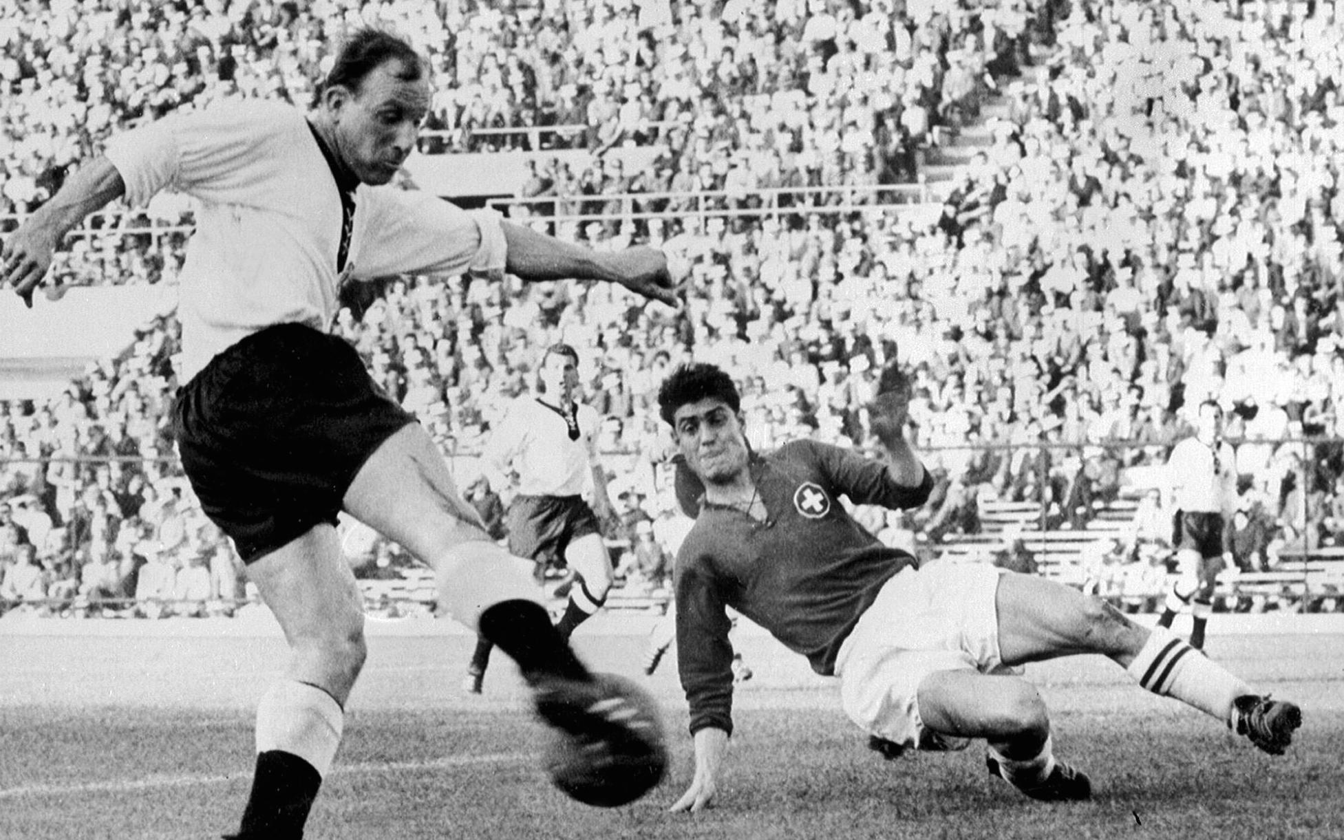SANTIAGO, CHILE - JUNE 3:  Swiss defender Heinz Schneiter (R) attempts to block the shot of German forward Uwe Seeler 03 J...