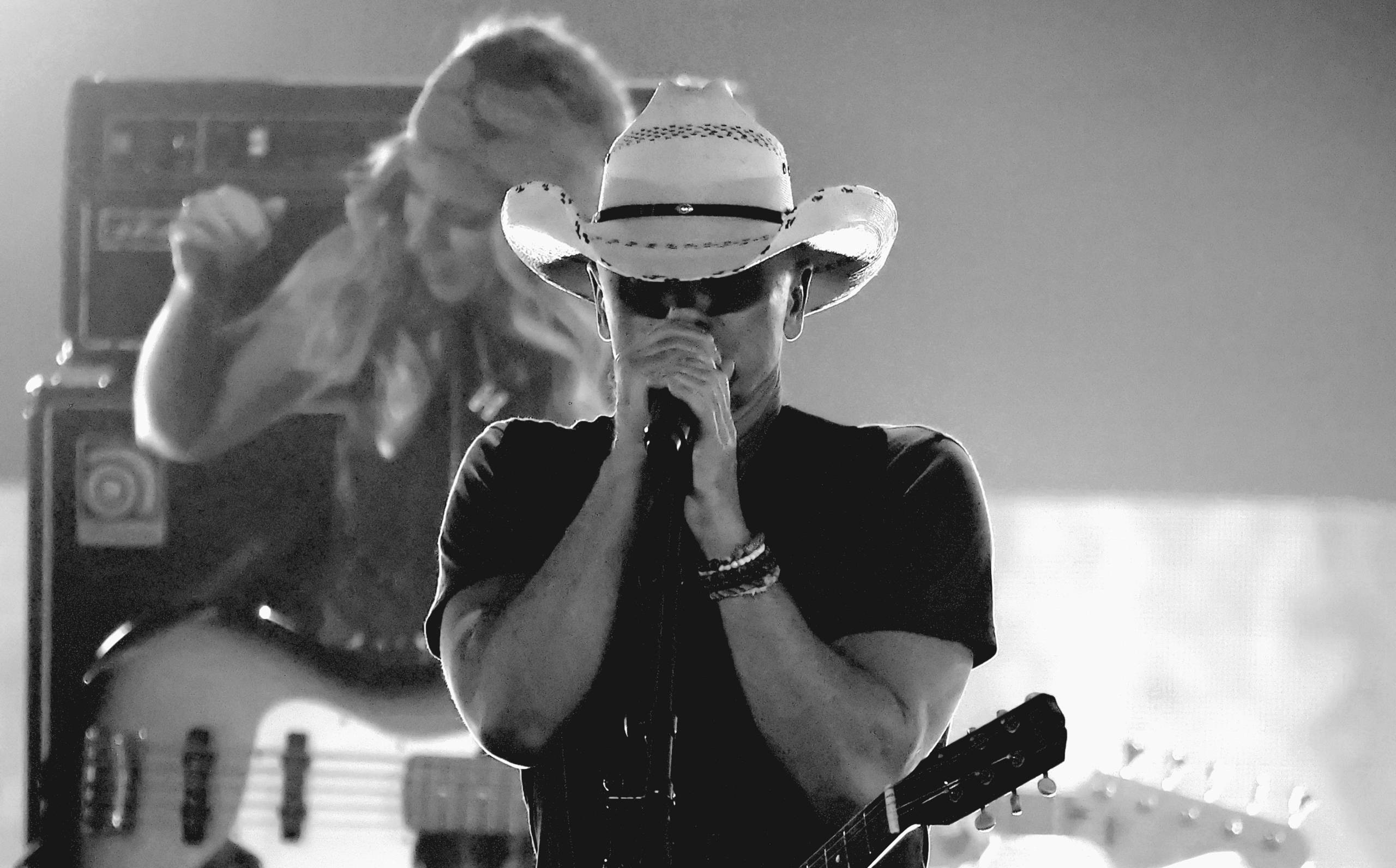 NASHVILLE, TENNESSEE - APRIL 11: (EDITOR’S NOTE: Image has been converted to black and white.) Kenny Chesney performs at...
