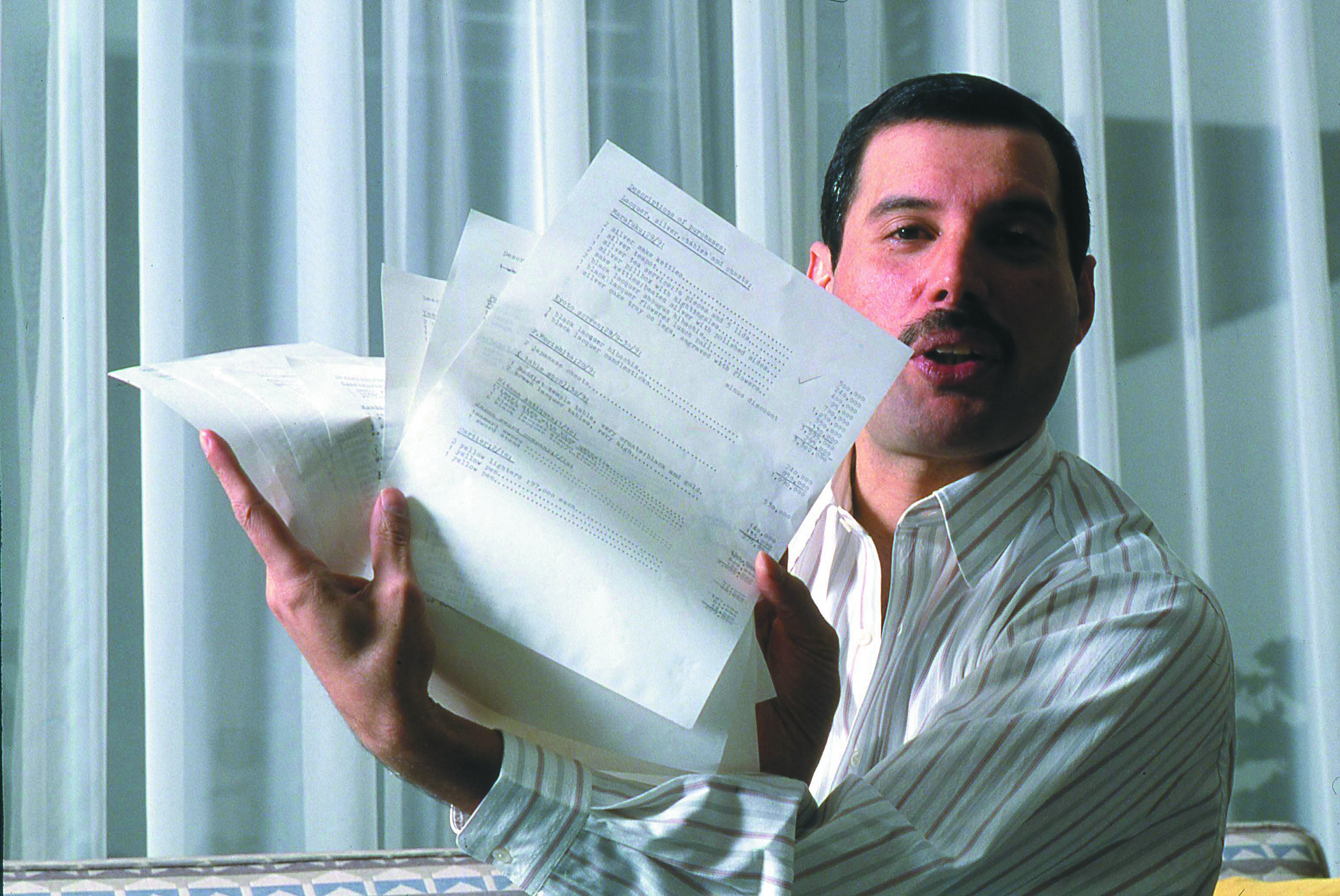 (MANDATORY CREDIT Koh Hasebe/Shinko Music/Getty Images) Freddie Mercury of Queen hold up shopping lists for the Japanese G...