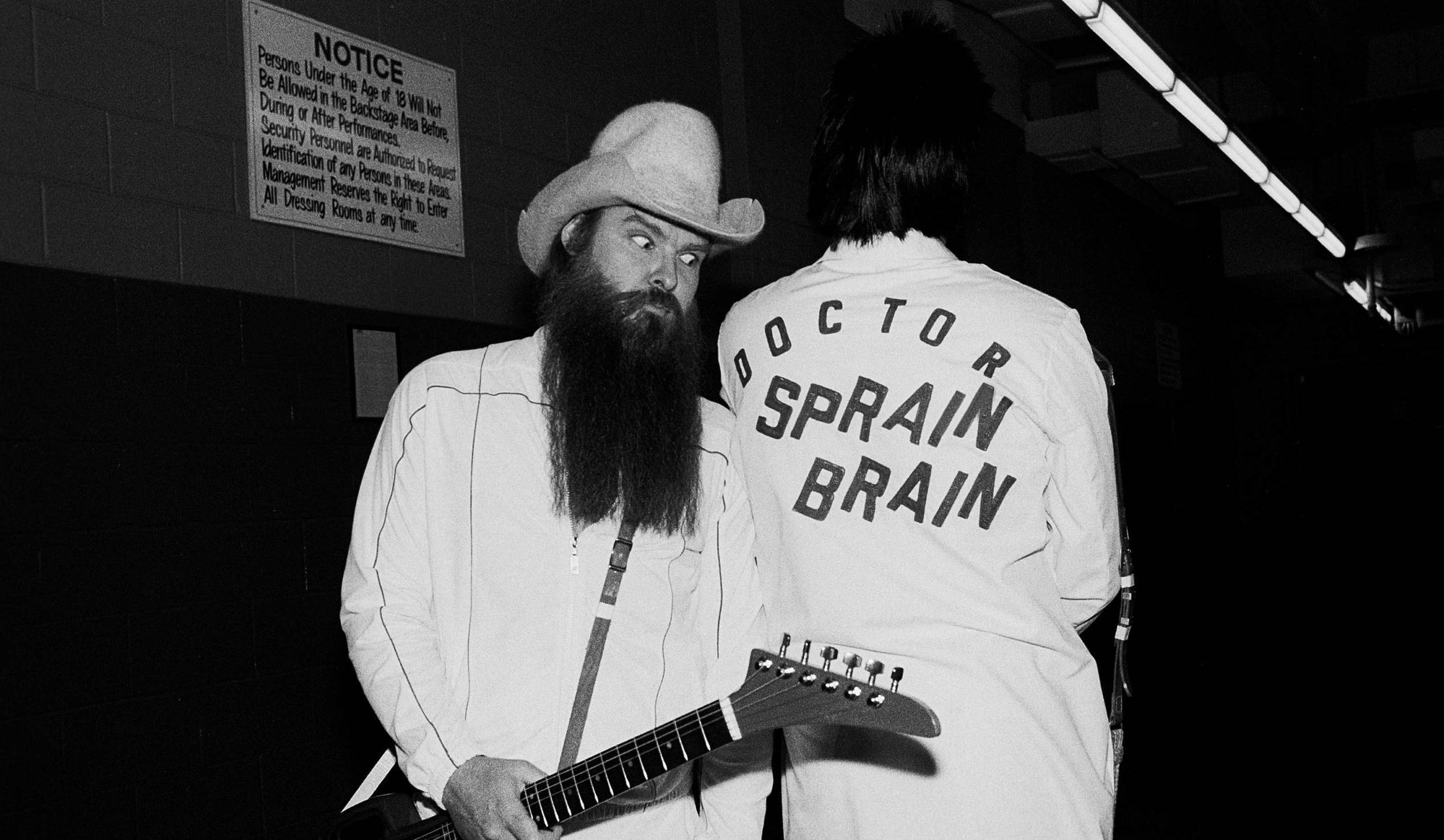 American Rock musician Billy Gibbons (left), of the group ZZ Top, poses backstage with his (unidentified) guitar tech at t...