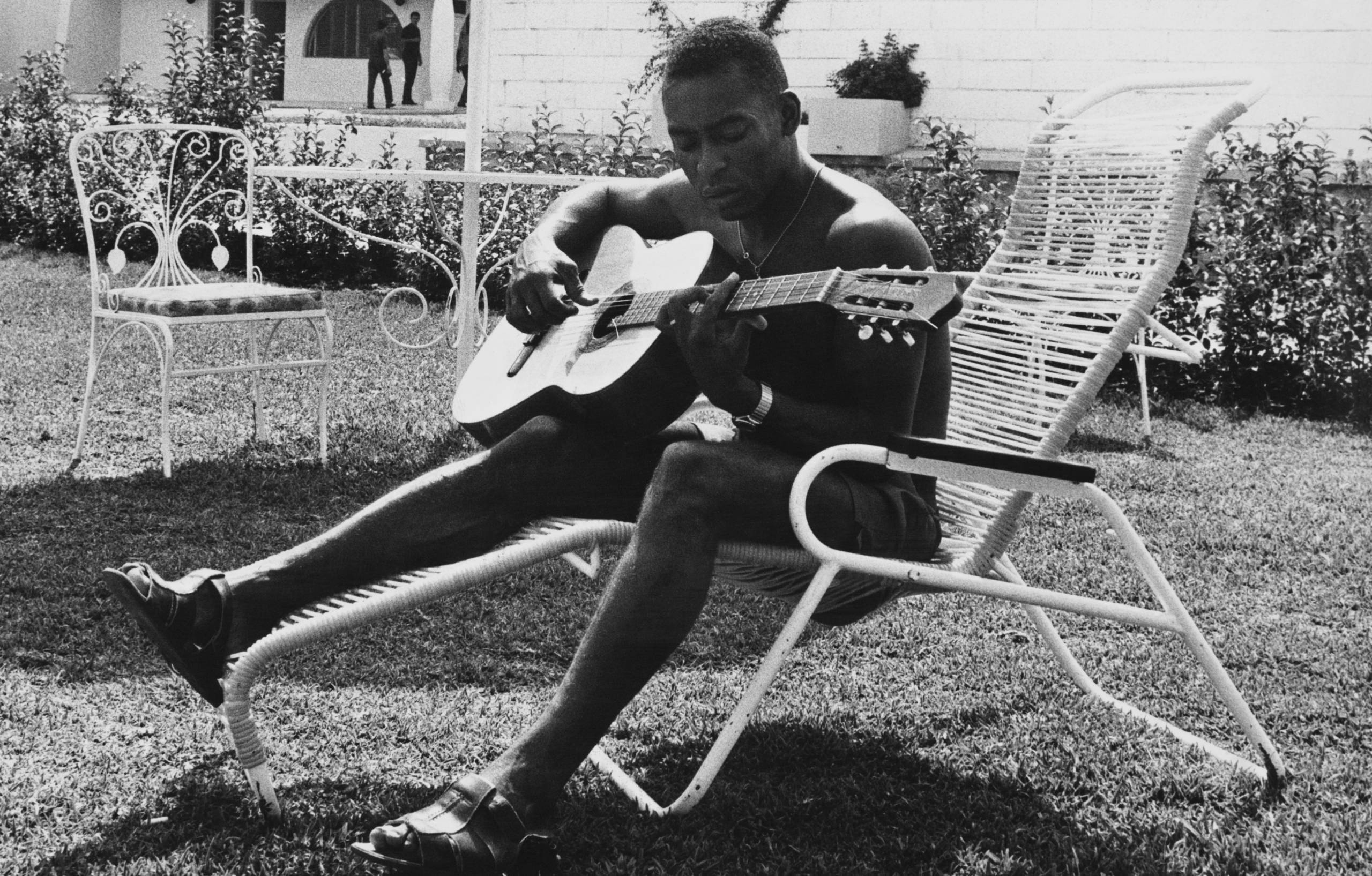 Brazilian footballer Pele relaxing with his guitar during the World Cup in Mexico, May 1970. (Photo by Pictorial Parade/Ar...