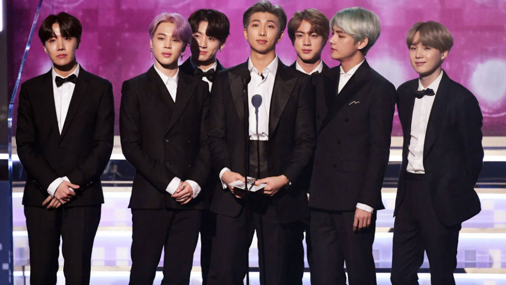 LOS ANGELES, CA - FEBRUARY 10:  RM (C) and fellow BTS members speak onstage during the 61st Annual GRAMMY Awards at Staples C
