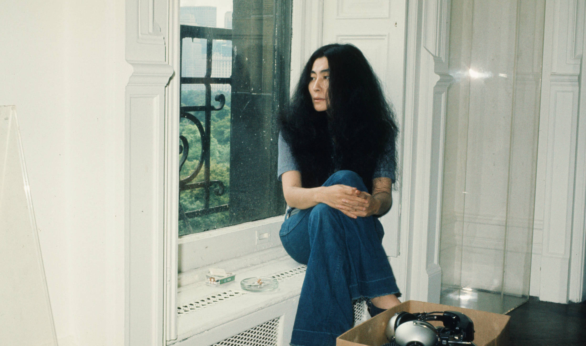 (MANDATORY CREDIT Koh Hasebe/Shinko Music/Getty Images) Yoko Ono sitting in the window of an apartment during an interview...