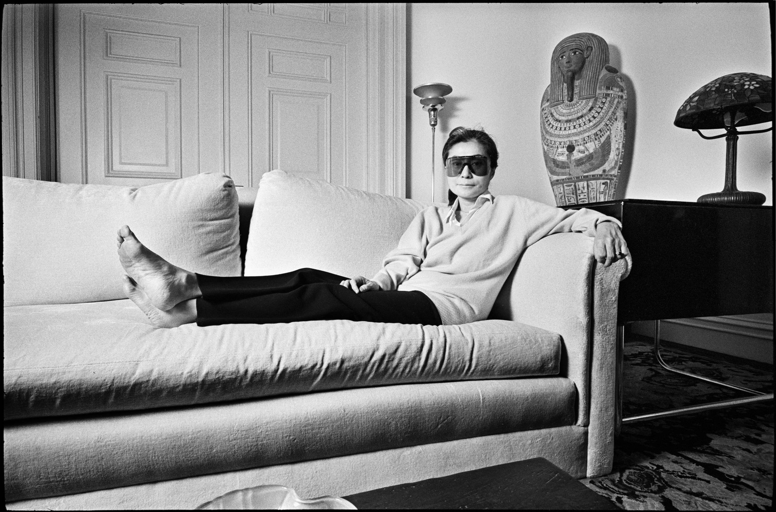 Portrait of Japanese multimedia artist and musician Yoko Ono, in a pair of Porsche-brand, wrap-around sunglasses, as she p...