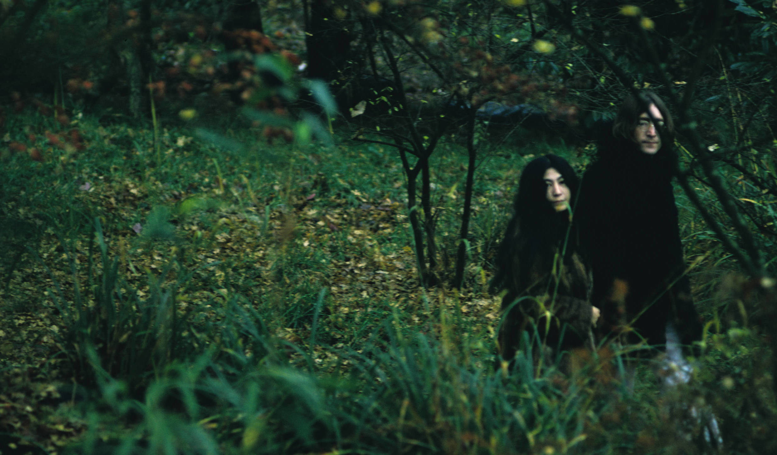 Japanese-born artist and musician Yoko Ono and British musican and artist John Lennon (1940 - 1980) walk outdoors, Decembe...