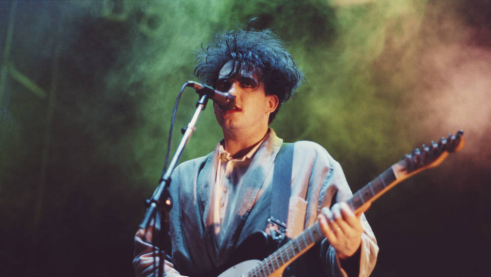 Robert Smith of The Cure performs on stage, Brazil, March 1987. (Photo by Michael Putland/Getty Images)