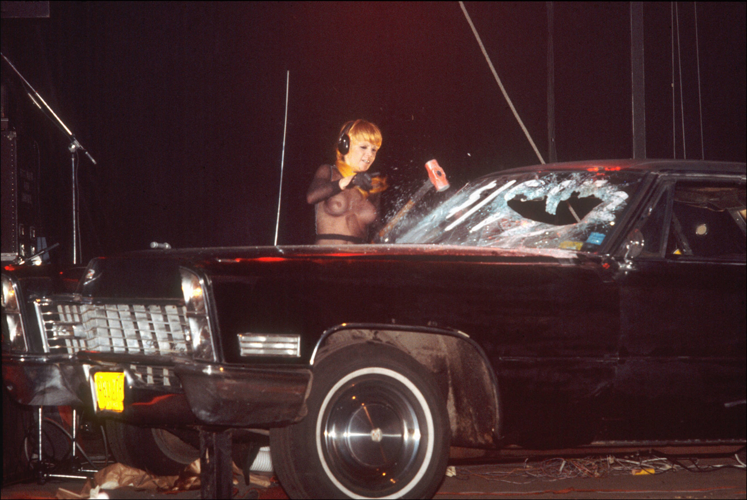 American musician Wendy O Williams, of the group the Plasmatics, demolishes a Cadillac during a concert, New York, New Yor...