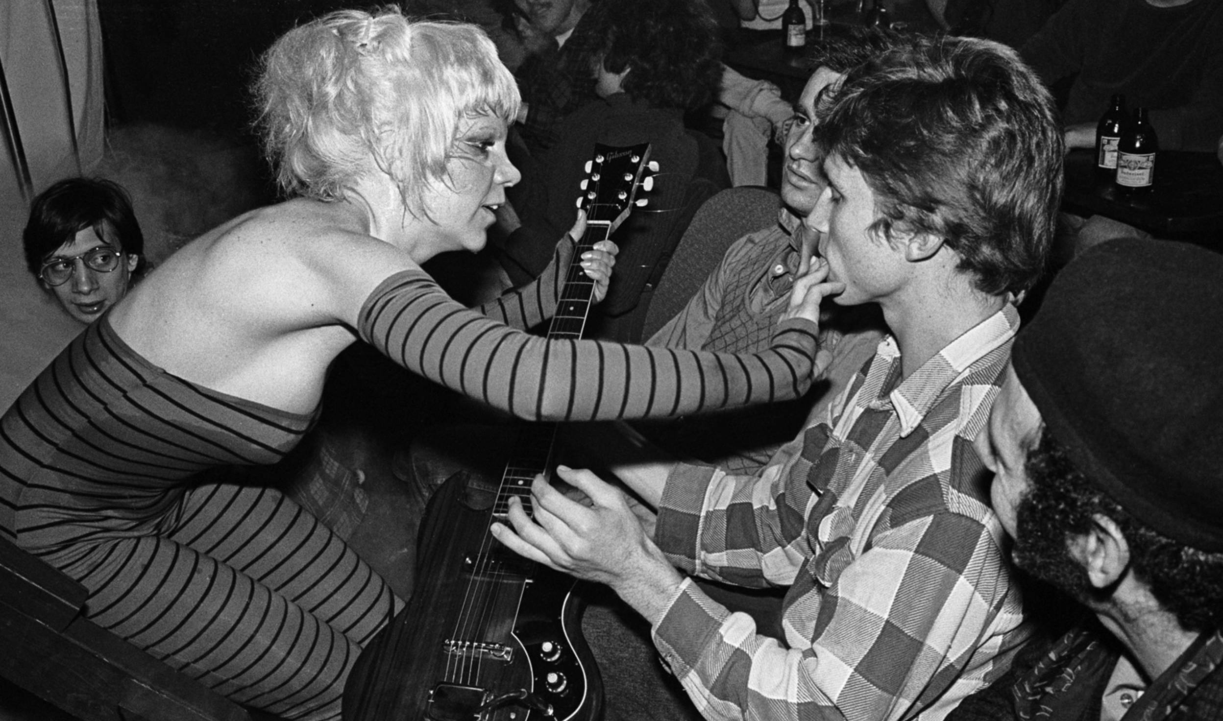 American musician Wendy O Williams, of the group the Plasmatics, puts her fingers in the mouth of a fan at CBGB during a c...