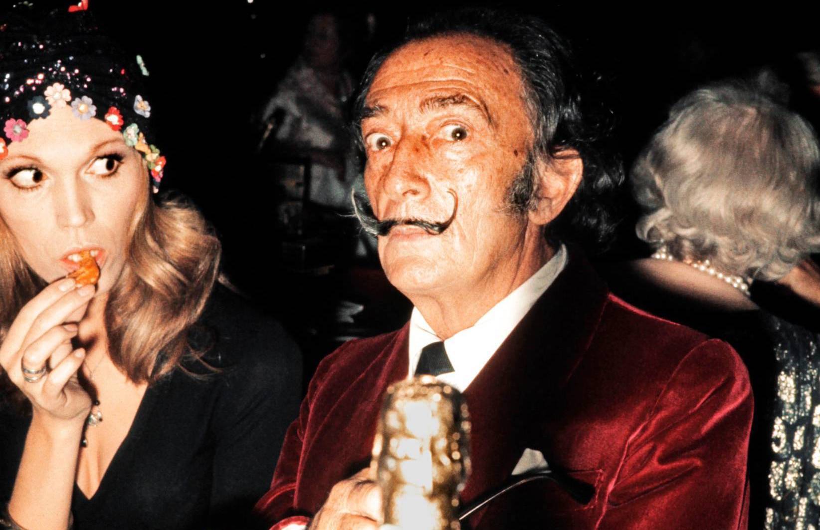 Spanish painter Salvador Dali and French actress and singer Amanda Lear have dinner in a restaurant in Paris in December 1...