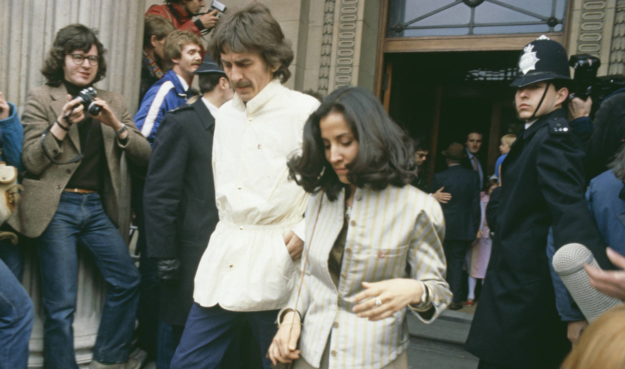 Former Beatle George Harrison and his wife Olivia Harrison, leaving Marylebone Register Office after the wedding ceremony ...