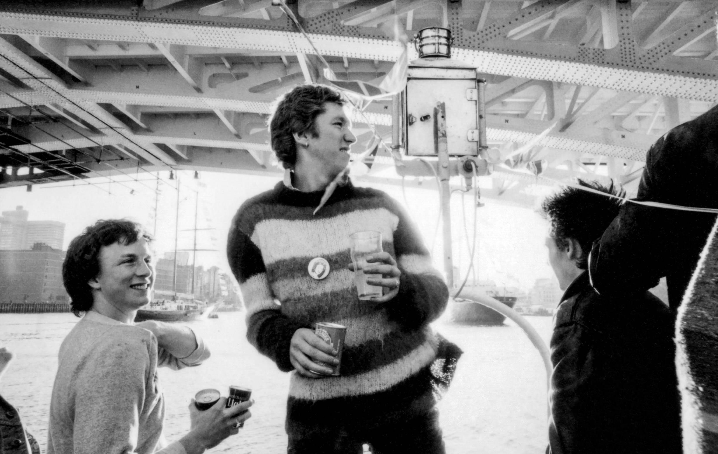LONDON - JUNE 1977: Steve Jones (centre) of the English punk rock band the Sex Pistols aboard the Queen Elizabeth on the R...