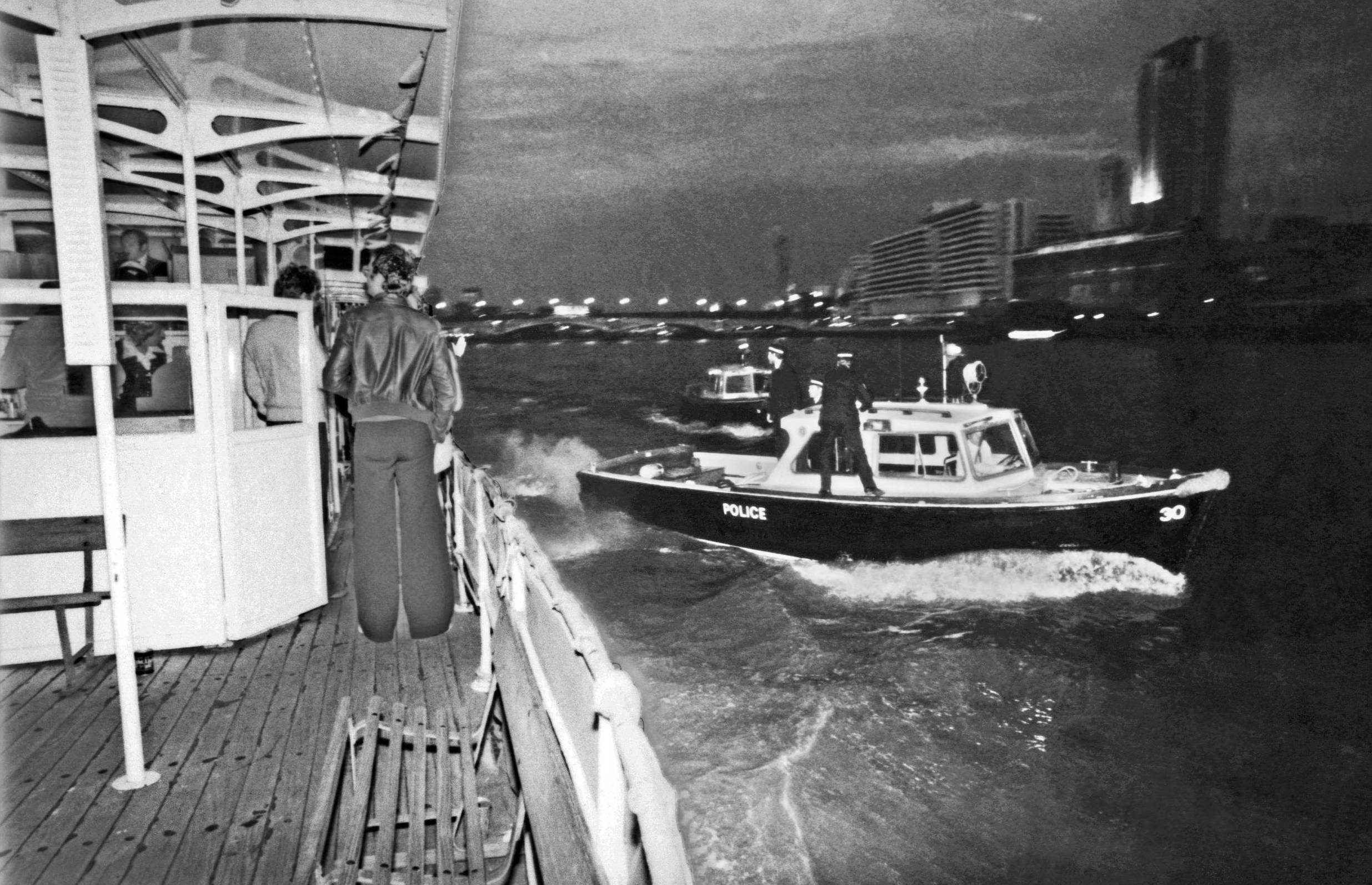 LONDON - JUNE 1977: Thames River Police boats circle the Thames cruiser the Queen Elizabeth during the English punk rock b...