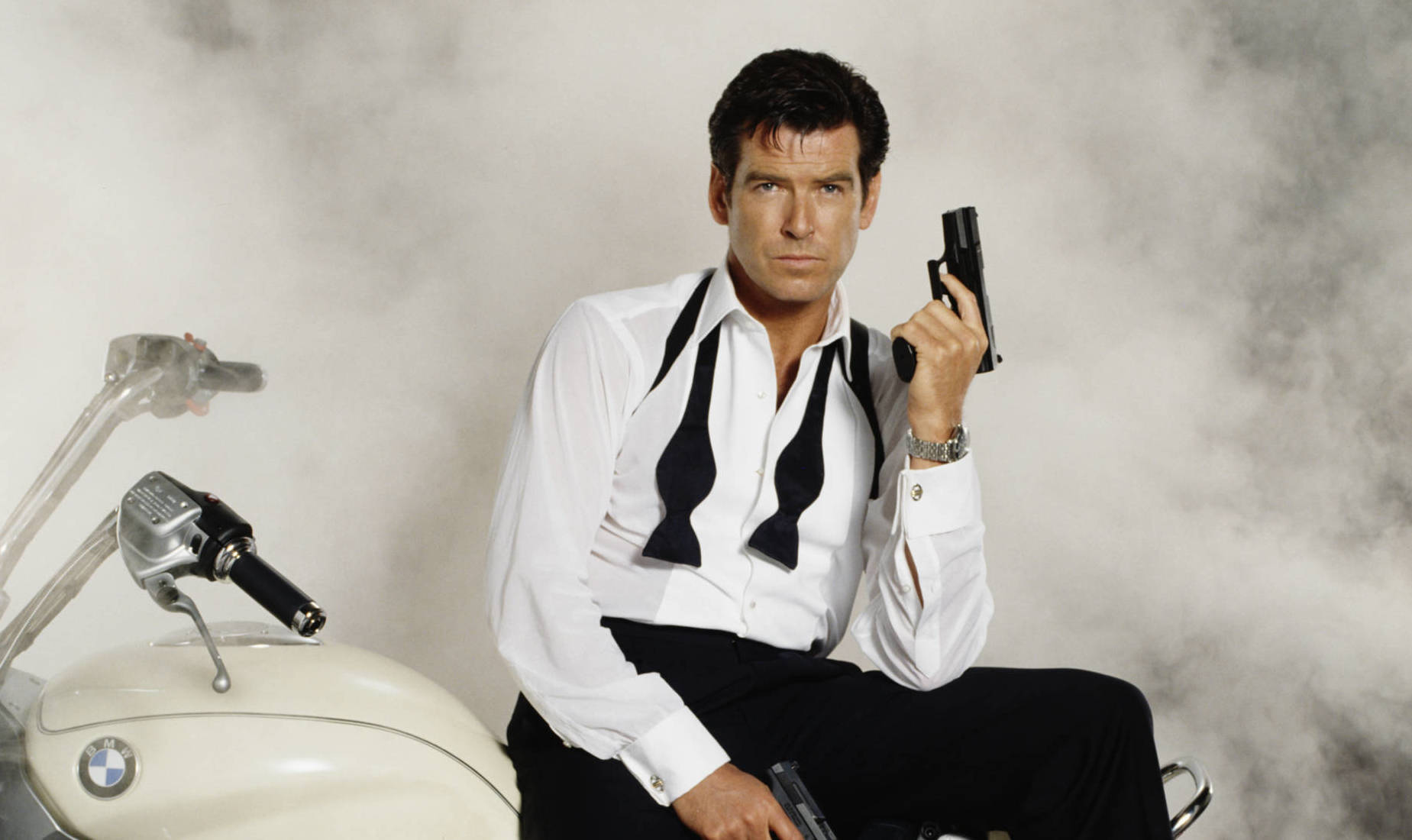 Irish actor Pierce Brosnan stars as 007 in the James Bond film 'Tomorrow Never Dies' 1997. He is sitting on a BMW R1200C a...