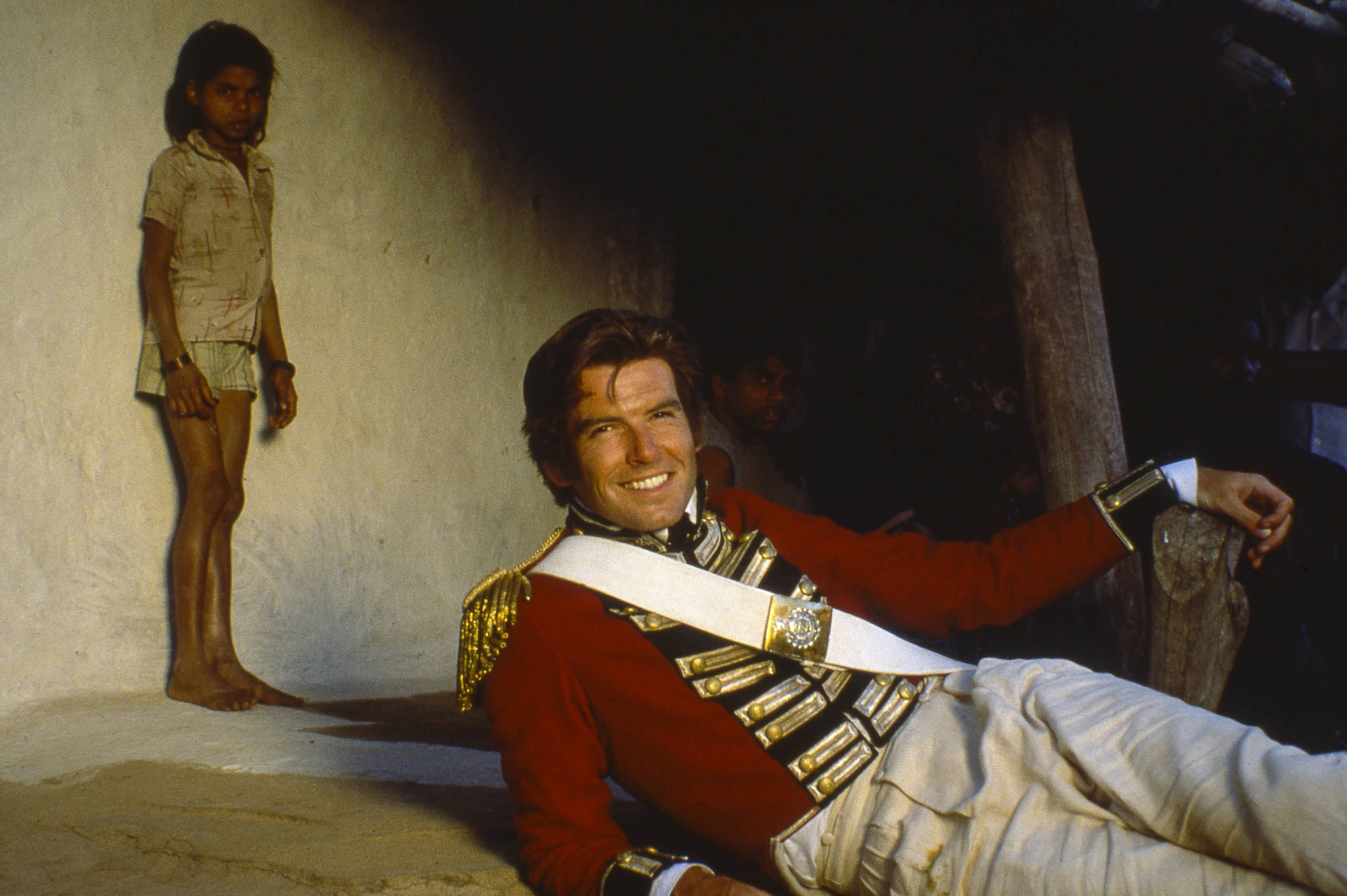 Portrait of Irish actor Pierce Brosnan (fore) (in costume as 'William Savage') and an unidentified child actor during the ...