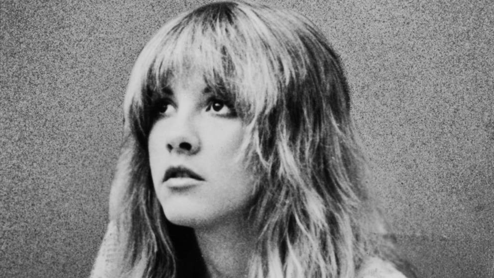 Promotional portrait of American pop and rock singer Stevie Nicks (of the group Fleetwood Mac) as she sits and looks upward, 