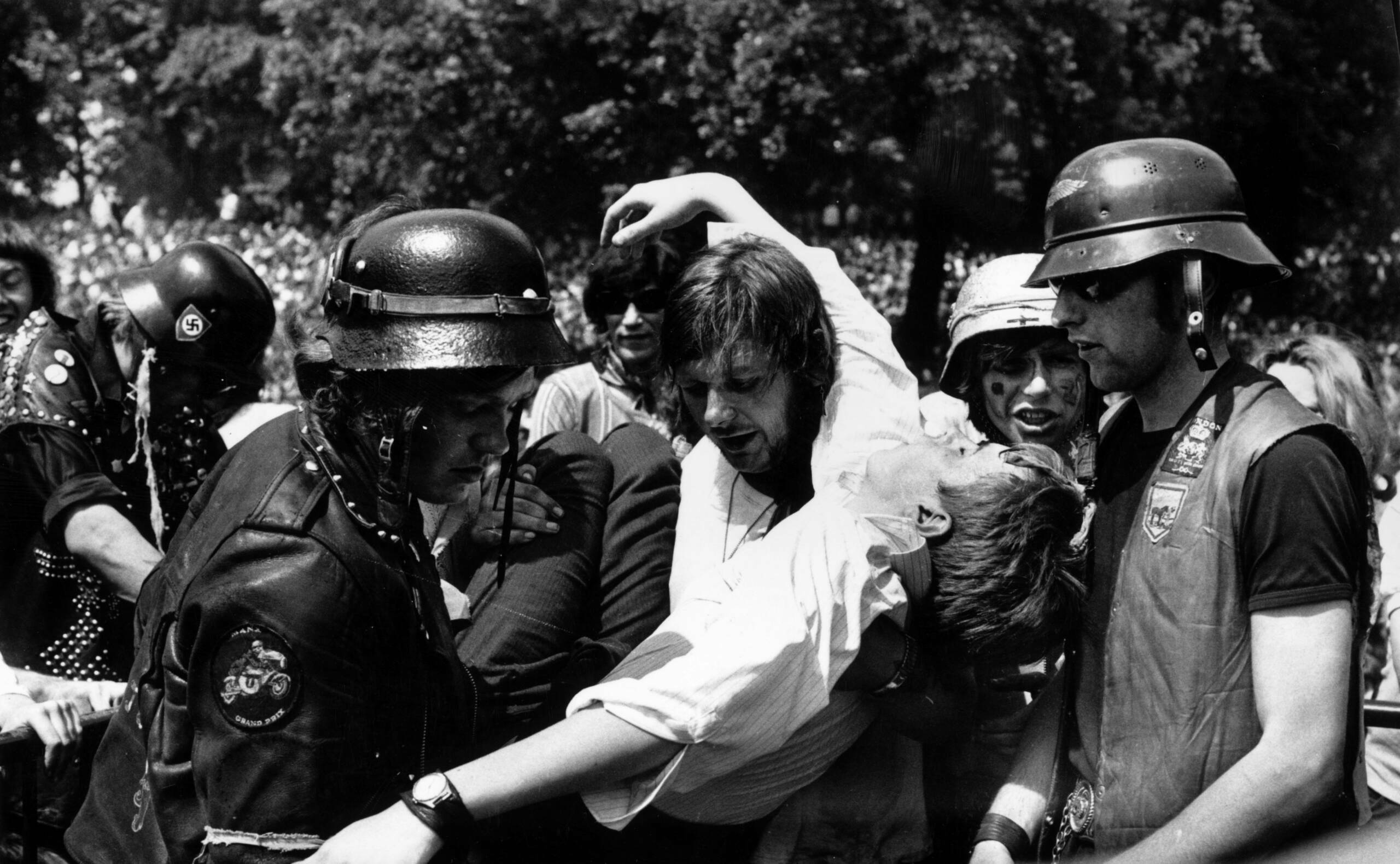 5th July 1969:  Hell's Angels, acting as security at the free Rolling Stones concert in Hyde Park, London, lifting a fan t...