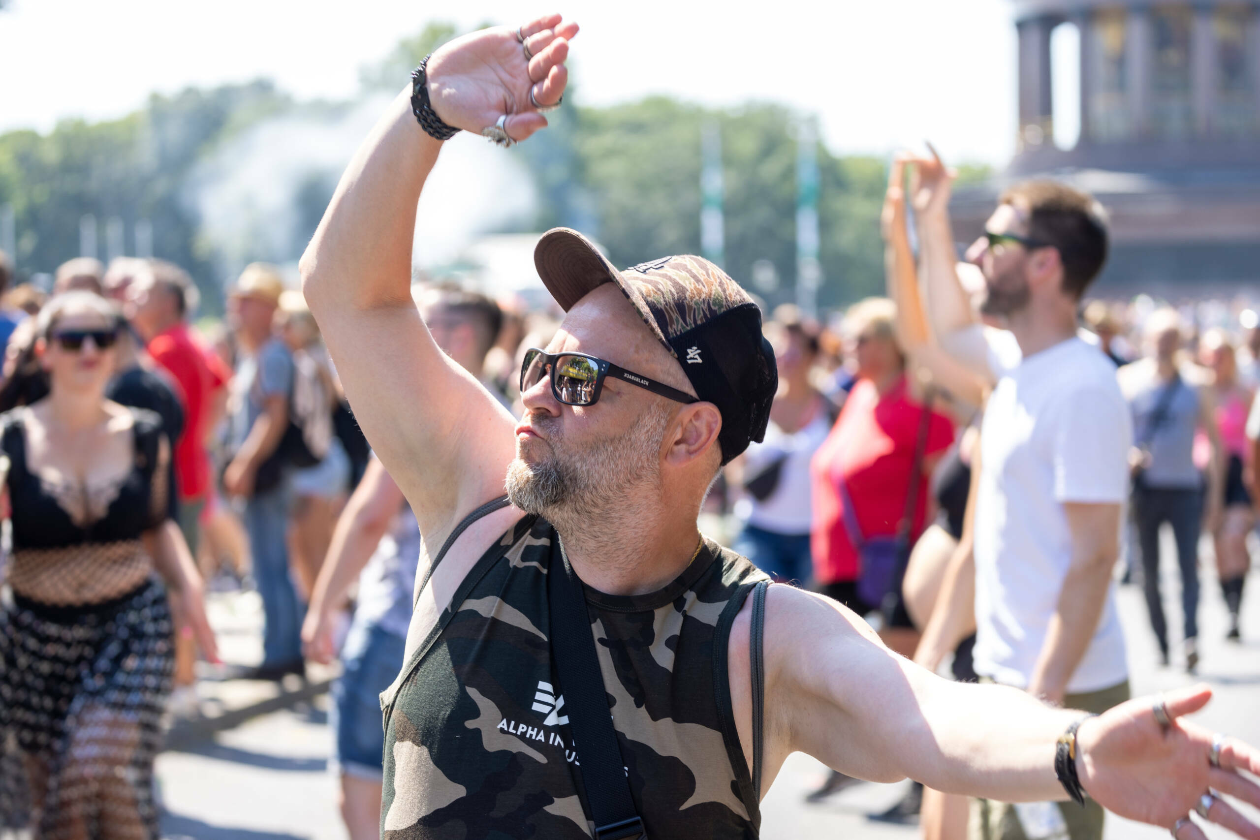 BERLIN, GERMANY - JULY 8: Techno music enthusiasts dance during the Rave the Planet parade in Tiergarten park at victory c...