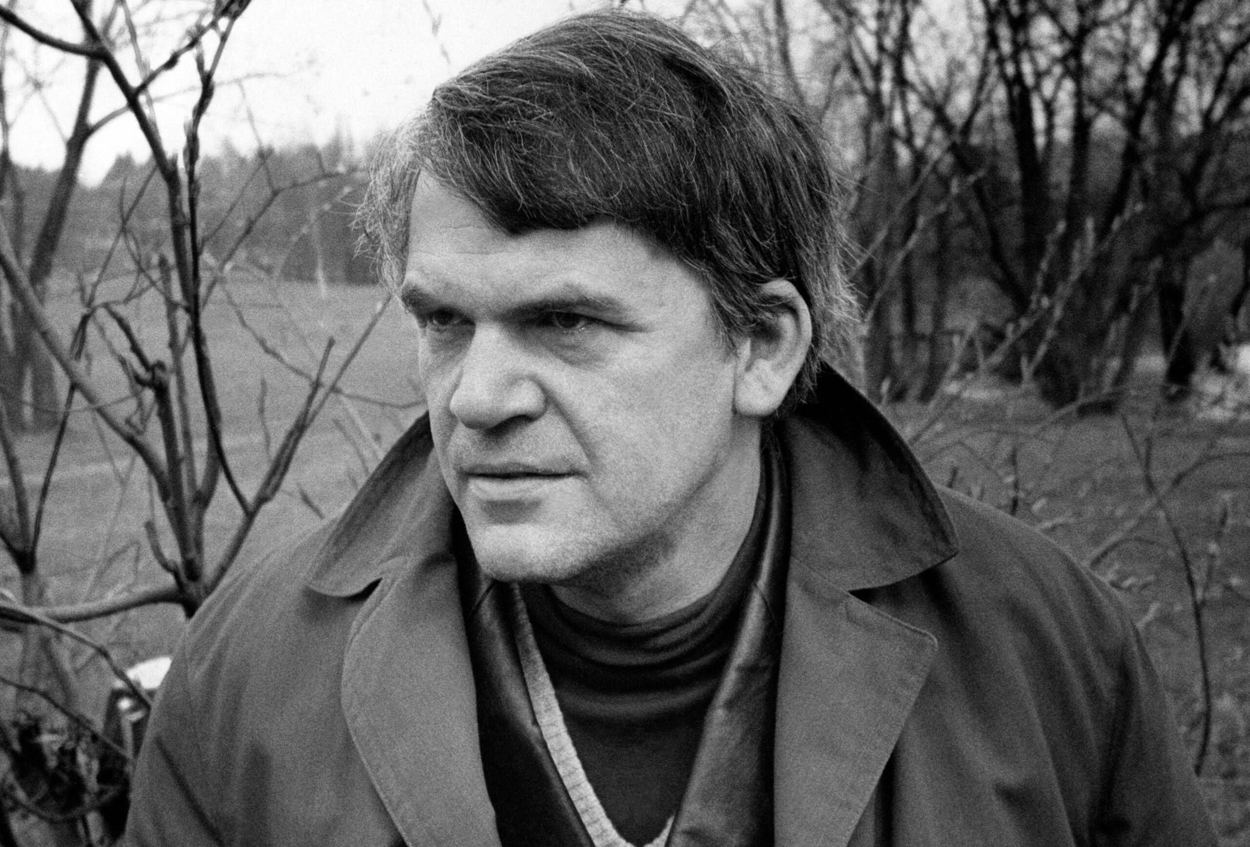 TOPSHOT - Czech writer Milan Kundera poses in a garden in Prague 14 October 1973. Novelist born in Brno, Czech Republic, K...