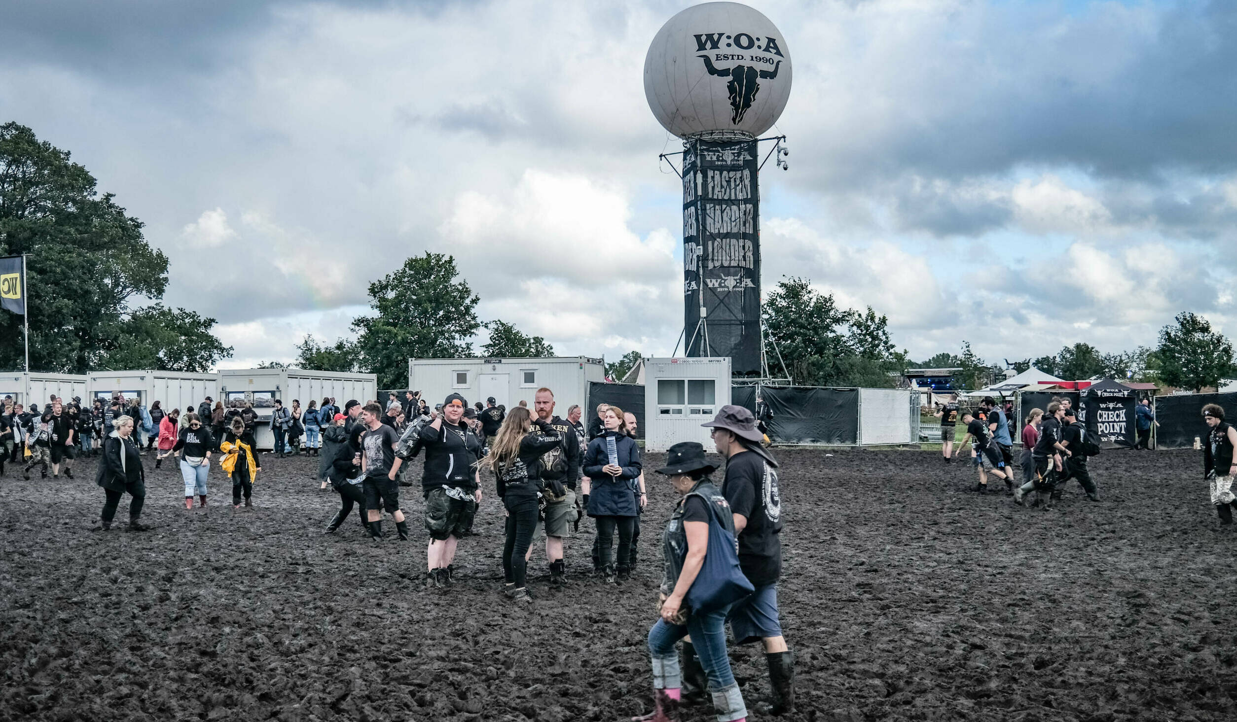 Visitors of the Wacken Open Air are fighting against the mud on the festival ground on August 1, 2023. Wacken Open Air, on...
